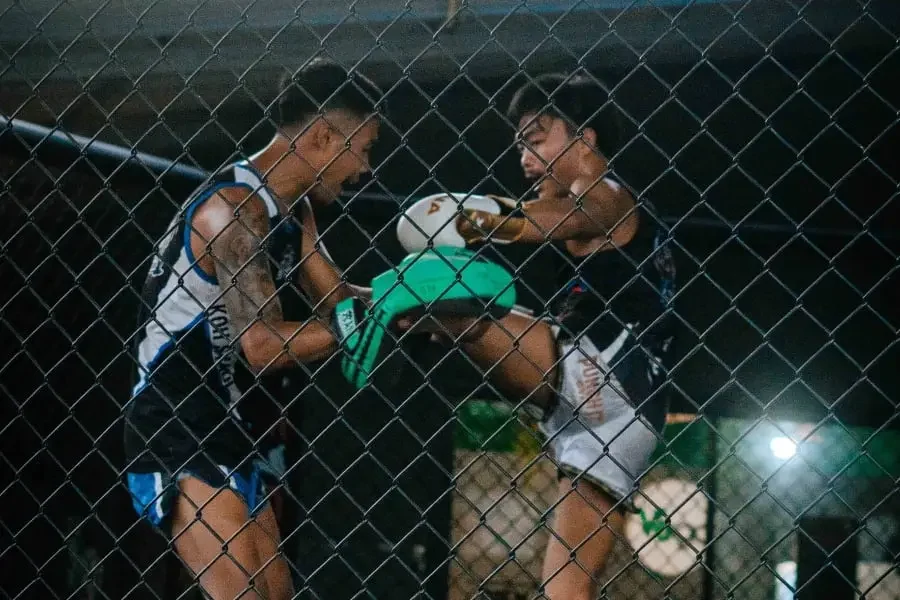 practicing kicks in the cage at BXB Fight Lab in Koh Samui